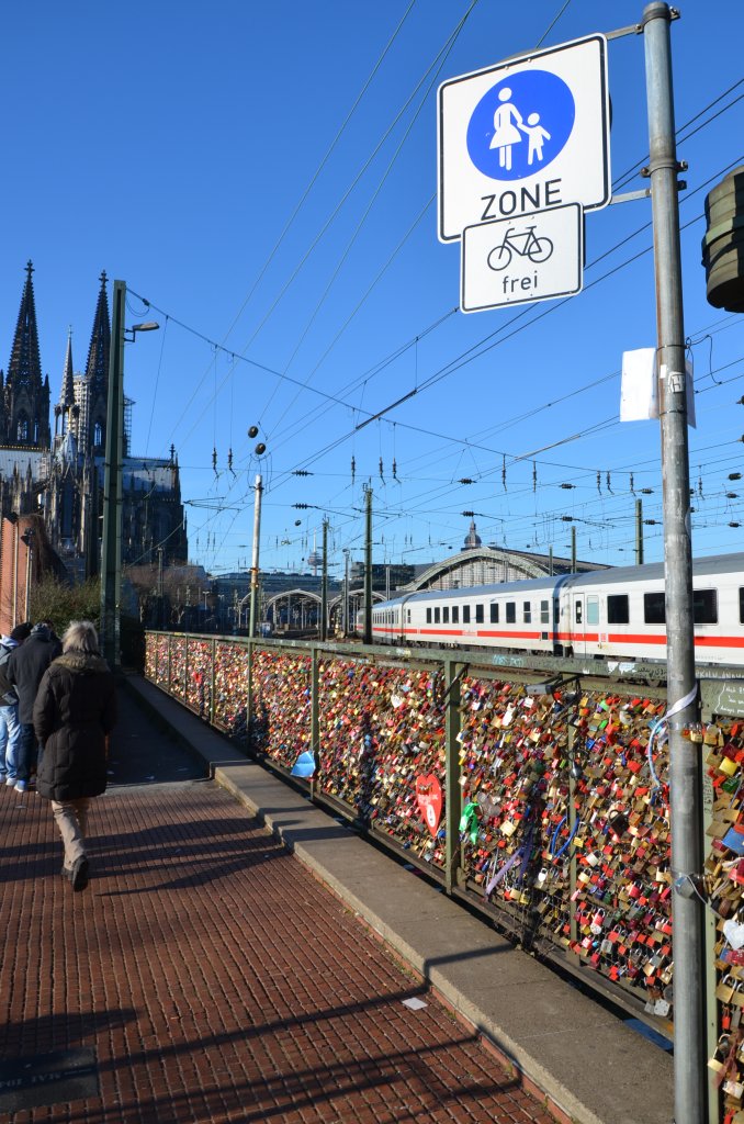 IC bei der Einfahrt in K�ln Hbf am 13.01.2013. Im Vordergrund an der westlichen Rampe zur Hohenzollernbr�cke sind die Liebesschl�sser angebracht. Man sch�tzt, dass allein an  dieser Br�cke 40.000 angebracht sind (http://de.wikipedia.org/wiki/Liebesschloss)