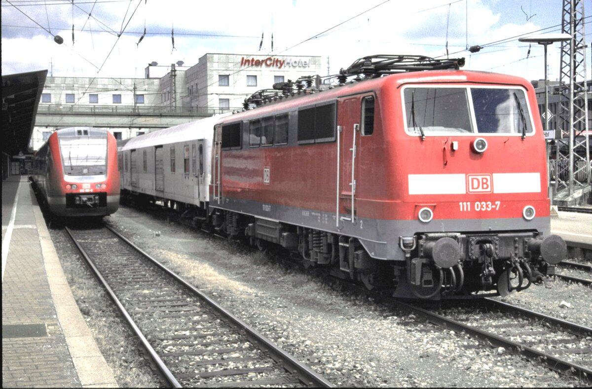 111 033-7 und 612 081-0 in Ulm am 02.08.2002. Der Packwagen hinter der 111 ist in grau lackiert und war lange in Ulm stationiet.