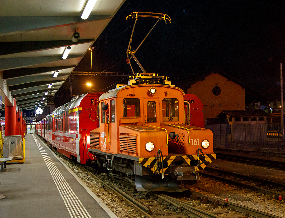 
Das RhB  Eselchen  161 bzw. der Rangiertraktor RhB Ge 2/2 161, ex BB Ge 2/2 61 rangiert am 18.02.2017 einige Wagen im RHB-Bahnhof Tirano. 

Der RHB-Bahnhof Tirano ist der Endbahnhof der Berninabahn und bedingt dadurch ein Kopfbahnhof. Bei den meist von Triebwagen geführten Züge werden dann die Personenwagen (teilweise auch Güterwagen) abgehangen und von der RhB Ge 2/2 auf ein anderes Gleis rangiert. Danach setzt der Triebwagen um und setzt sich für die Gegenrichtung wieder vor die Wagen.

Von der kleinen Elektrolokomotive Ge 2/2 wurden nur zwei Loks von diesem Typ für Berninabahn (BB) , heute der Rhätischen Bahn (RhB), gebaut, ursprünglich die BB 61 und BB 62, seit 1961 mit den Nummern RhB 161 und 162.

Beide Gleichstromloks wurden 1911 von der Berninabahn (BB) für Vorspanndienste beschafft, sie wurden von SIG und Alioth gebaut. Die damals noch braun lackierten Maschinen erhielten die Nummern Ge 2/2 61 und 62 und waren noch mit Lyra-Stromabnehmern bestückt. Nach der Übernahme der BB durch die RhB im Jahre 1942 wurden sie verschiedentlich modernisiert; sie tragen heute einen Einholmstromabnehmer und sind meistens als Rangierloks in Tirano und Poschiavo tätig.

Sie werden wegen ihrer Form auch  Mini-Krokodile  oder wegen ihres Aufgabenbereichs  Eselchen  genannt.  Zwischen den Vorbauten ist ein Gang, so dass ein Übergang zum Zug möglich war. Die Benutzung ungeschützter Übergänge ist aber inzwischen selbst dem Personal untersagt, so wurden folgerichtig an den beiden Loks die Übergangsbleche entfernt. Die Loks sind die zweitältesten im Dienst befindlichen Lok der RHB.

Technische Daten der Ge 2/2
Betriebsnummern: 161 und 162 (ex 61 und 62)
Hersteller: SIG, Alioth
Baujahr: 1911
Anzahl Fahrzeuge: 2
Spurweite: 1.000 mm
Achsanordnung: B
Länge über Puffer: 7.740 mm
Breite: 2.500 mm
Achsabstand: 
Triebraddurchmesser (neu): 975 mm
Dienstgewicht:  18.0 t
Höchstgeschwindigkeit: 45 km/h
Stundenleistung: 250 kW (340 PS)
Anfahrzugkraft: 37,6 kN
Stundenzugkraft: 27,5 kN bei 27 km/h
Motorentyp:  Gleichstrom Reihenschluss
Fahrleitungsspannung: 1 kV DC (Gleichstrom) / 750 V DC vor 1935 