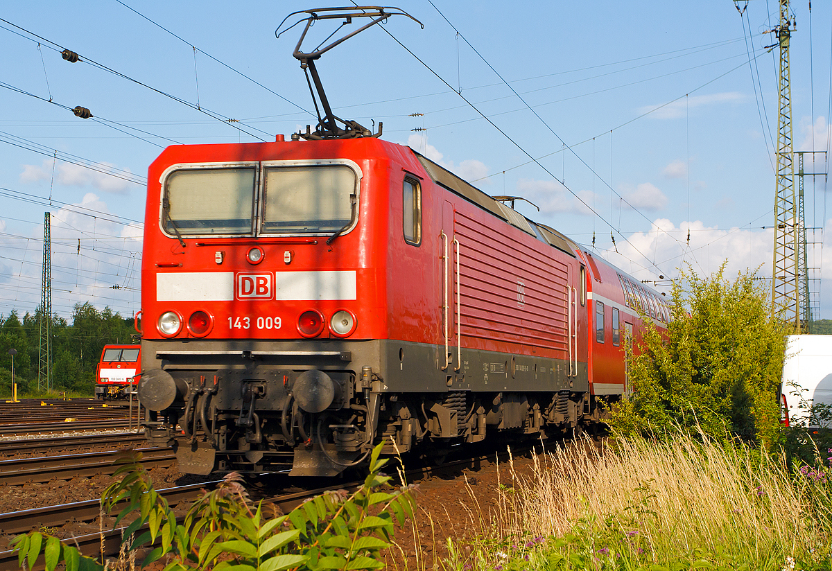 
Die DB 143 009-9, ex DR 243 009-8, schiebt die RB 27   Rhein-Erft-Bahn    (M�nchengladbach - K�ln - Bonn-Beuel - Neuwied - Koblenz Hbf) durch Koblenz-L�tzel in Richtung Koblenz Hbf.

Die Lok wurde 1984 bei LEW (VEB Lokomotivbau Elektrotechnische Werke Hans Beimler Hennigsdorf) unter der Fabriknummer 18232 gebaut und als DR 243 009-8 an die Deutsche Reichsbahn geliefert, 1992 erfolgte die Umzeichnung in DR 143 009-9 und zum 01.01.1994 in DB 143 009-9. 

Ein Umbau (Einbau Notbrems�berbr�ckung (NB�) und elektropneumatischer Bremse (ep) erfolgte 2006 und 2012 die Hochr�stung auf NB� 2004.
Die Notbrems�berbr�ckung (NB�) dient bei Personenz�gen dazu, den Zug trotz bet�tigter Notbremse weiterfahren zu lassen und erst an einem besser geeigneten Ort zum Stillstand zu bringen. Grund f�r ihre Einf�hrung war, dass das Halten eines brennenden Zuges in einem Tunnel zu verheerenden Folgen f�hren kann, aber auch, dass ein Zug, der an einem schwer zug�nglichen Punkt zum Stehen kommt, die Bergung erschwert. Die Notbrems�berbr�ckung darf vom Triebfahrzeugf�hrer nur in besonders gekennzeichneten Streckenabschnitten angewandt werden.

Bei der NB� 2004 f�hrt die Bet�tigung einer Notbremse allerdings zun�chst nur zu einer optischen und akustischen Meldung im F�hrerstand. Der Triebfahrzeugf�hrer muss diese Meldung entweder durch einen �berbr�ckungsbefehl oder durch eine Schnellbremsung best�tigen. Andernfalls wird die Notbremsung nach kurzer Zeit selbstt�tig wirksam.

Die Lok tr�gt seit 2007 die NVR-Nummer  91 80 6143 009-9 D-DB und die EBA-Nummer  EBA 01C17A 009   .