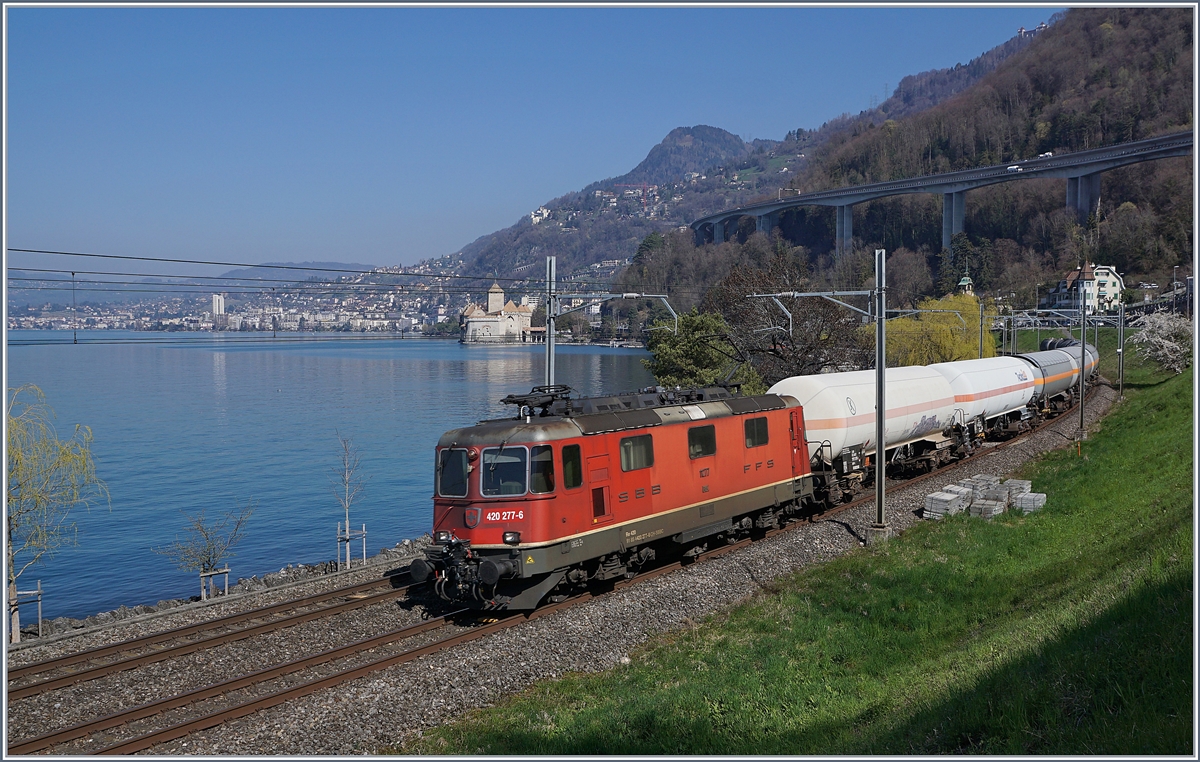 Die SBB Cargo Re 420 277-5 ist mit ihrem G�terzug bei Villeneuve vor der Kulisse des Ch�teau de Chillon Richtung Wallis unterwegs. 

29. M�rz 2019