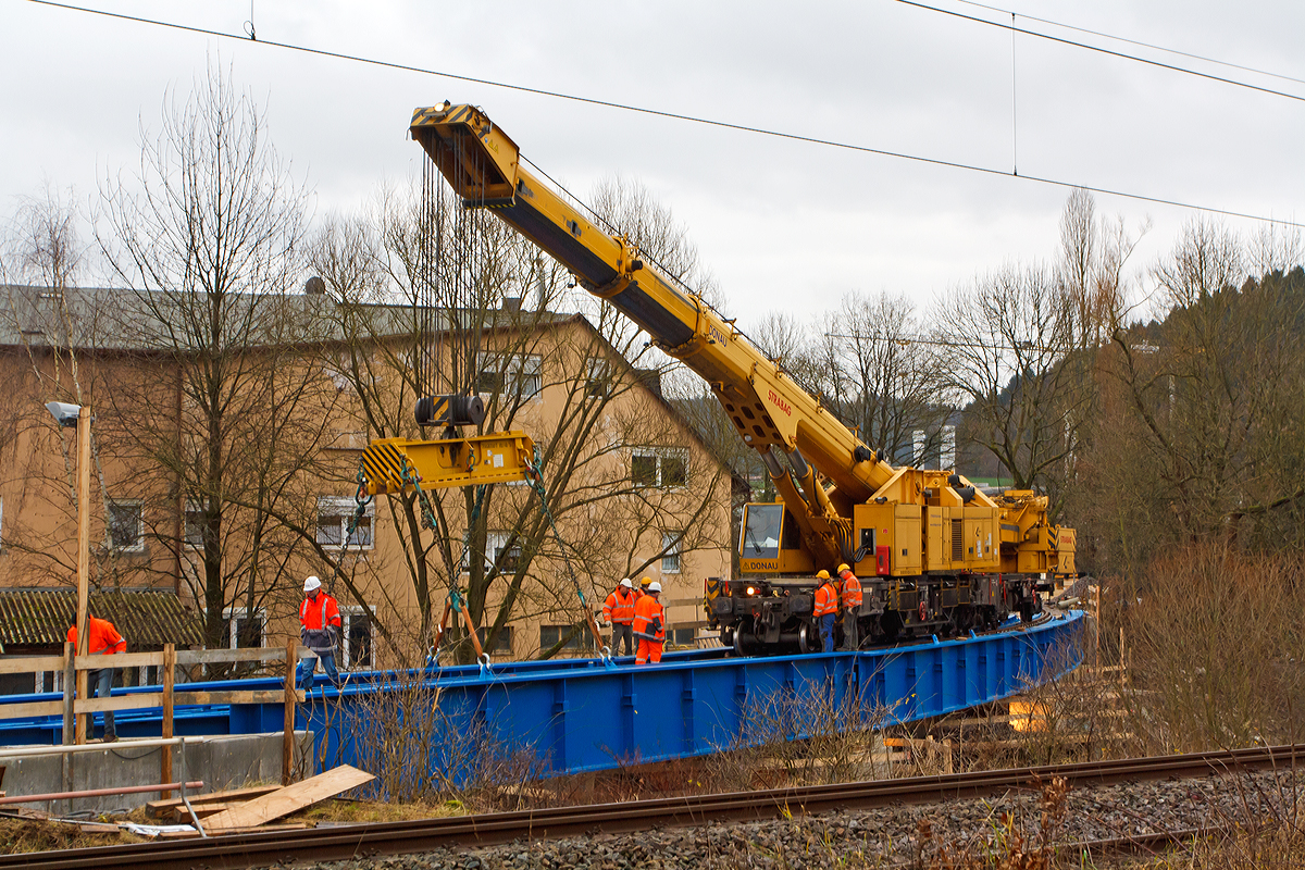 
Einsatz von dem 150 t Kirow Gleis- und Weichenbaukran KRC 1200+ (ein Kirow MULTI TASKER KRC 1200+) 99 80 9419 005-0 D-STRA  „DONAU“  (ex 97 82 55 508 17-5) der STRABAG RAIL GmbH, bei der Montage am 20.12.2014 vom Br�ckenoberbau der KSW Eisenbahnbr�cke �ber die Sieg in Siegen.

Ausf�hrliche Beschreibung siehe: http://hellertal.startbilder.de/bild/deutschland~unternehmen~ksw-kreisbahn-siegen-wittgenstein-ehem-siegener-kreisbahn/392524/der-ksw-bahnhof-siegen-eintracht-betriebsbereich-eisern-siegener.html
