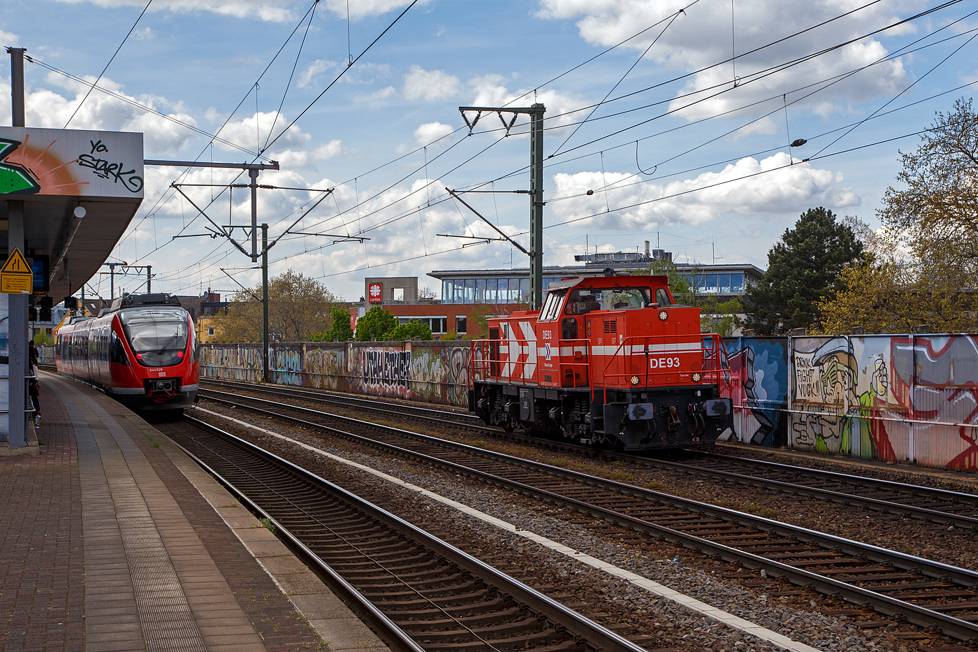 Die RheinCargo DE 93 alias 272 011-4 (98 80 0272 011-4 D-RHC), eine MaK DE 1002 der RheinCargo fährt am Sonntag den 30.04.2023 als Lz (Lokzug) bzw. auf Tfzf (Triebfahrzeugfahrt) durch den Bahnhof Köln-Ehrenfeld in Richtung Köln-Nippes.

Die Lok wurde 1986 von der Krupp-MaK Maschinenbau GmbH in Kiel unter der Fabriknummer 1000835 gebaut. 1999 wurde sie durch Adtranz (ABB Daimler Benz Transportation GmbH) in Kassel mit einem 12-Zylinder Dieselmotor vom Typ MTU 12V 4000 R20 remotorisiert, zum dem wurde die Leittechnik umgebaut.

Lebenslauf und Bezeichnungen:
1987 bis 1991 - KBE DE 83 (Köln-Bonner Eisenbahnen AG) 
1992 bis 06.1997 - HKG DE 83 (Häfen Köln GmbH) 
07.1992 bis 2012 HGK DE 93 (Häfen und Güterverkehr Köln AG)
Seit 01.08.2012 RHC DE 93 – (RheinCargo GmbH & Co. KG)

Im Jahr 2012 schlossen sich die Häfen und Güterverkehr Köln AG (HGK) und die Neuss-Düsseldorfer Häfen GmbH & Co. KG (NDH) zur heutigen RheinCargo GmbH & Co. KG zusammen.

TECHNISCHE DATEN:
Spurweite: 1.435 mm
Achsfolge: Bo´Bo´
Länge über Puffer: 13.100 mm
Drehzapfenabstand: 6.800 mm
Achsabstand im Drehgestell: 2.100 mm
größte Breite 3.100 mm
größte Höhe über Schienenoberkante: 4.220 mm
Treibraddurchmesser: 1000 mm (neu)
kleinster befahrbarer Gleisbogen: 60 m
Dienstgewicht: 90 t
Kraftstoffvorrat: 2.900 l
Motor: MTU-12-Zylinder-Dieselmotor, vom Typ 12V4000R20, ursprünglich MWM (Motorenwerke Mannheim) TBD604BV12 
Leistung: 1.500 kW bei 1800 U/min
Hersteller der Leistungsübertragung ist ABB (Generator, Fahrmotoren)
Höchstgeschwindigkeit: 90 km/h

Für die Niederländische Staatsbahn (NS) wurde auf Basis der DE 1002 die MaK DE 6400 entwickelt.

