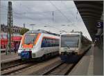 Ein bunter Hamster (UIC 9480 1442 650-6 D-SWEG) neben dem schlichten VT 650 in Freiburg im Breisgau .